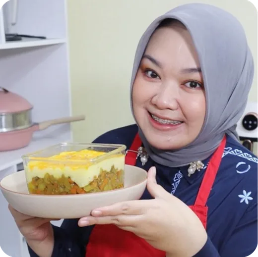 Nadia Aspintari holding a dish she cooked